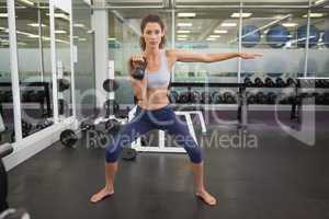 Fit woman working out with kettlebell