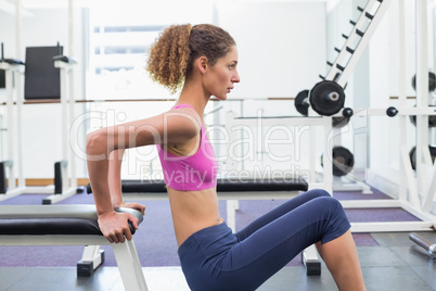 Fit woman exercising using the bench