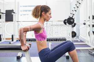 Fit woman exercising using the bench