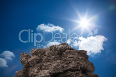 Large rock overlooking bright blue sky