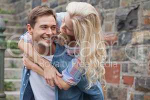 Man giving his pretty girlfriend a piggy back