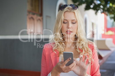 Pretty blonde sending text message