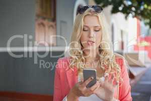 Pretty blonde sending text message