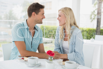 Hip young couple having desert and coffee together