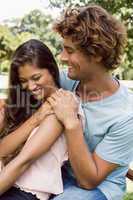 Cute couple laughing and hugging in the park