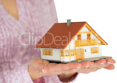 Hands showing a miniature model home