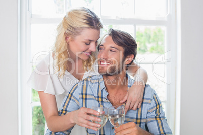 Cute smiling couple enjoying white wine together