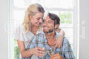 Cute smiling couple enjoying white wine together