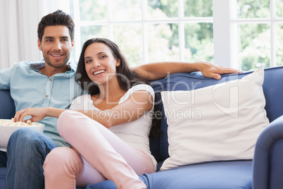 Attractive couple watching tv on the couch