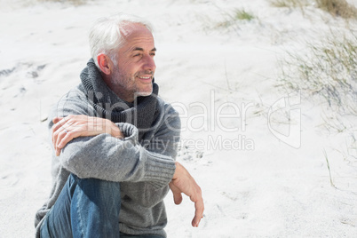 Attractive man smiling on the beach in scarf