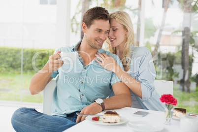 Hip young couple enjoying coffee and desert together