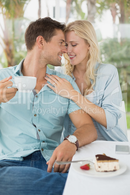 Hip young couple enjoying coffee and desert together