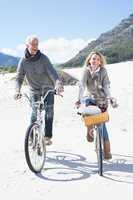 Carefree couple going for a bike ride and picnic on the beach