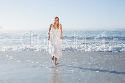 Pretty blonde at the beach in white sundress