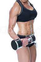 Female bodybuilder working out with large dumbbells mid section