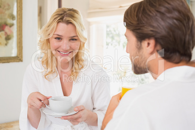 Couple having breakfast in their bathrobes