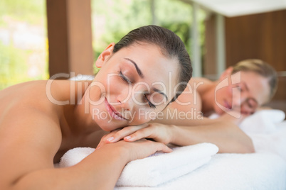 Peaceful friends lying on massage tables