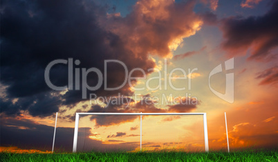 Football goal under orange cloudy sky