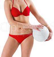 Sexy girl in red bikini holding football