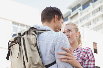 Young tourist couple smiling at each other