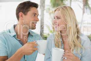 Hip young couple having coffee together