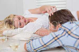 Cute young couple lying on floor together