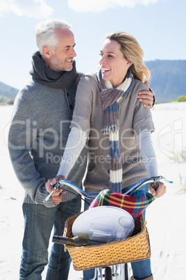 Carefree couple going on a bike ride and picnic on the beach