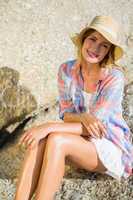 Pretty blonde smiling at camera at the beach