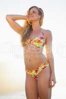 Gorgeous blonde in floral bikini posing at the beach