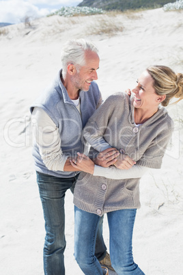 Attractive couple messing about on the beach