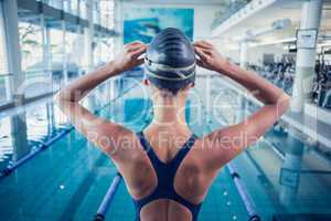 Pretty swimmer standing by the pool