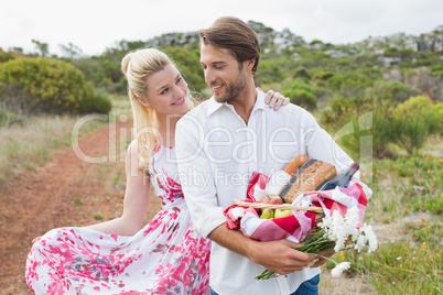 Cute couple going for a picnic smiling at each other