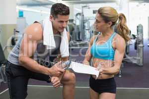 Bodybuilder talking with his personal trainer