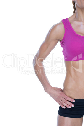 Female bodybuilder posing with hand on hip with copy space