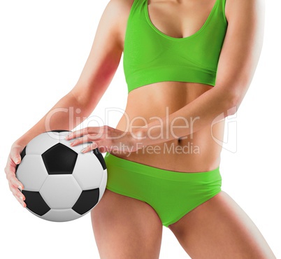 Fit girl in green bikini holding football