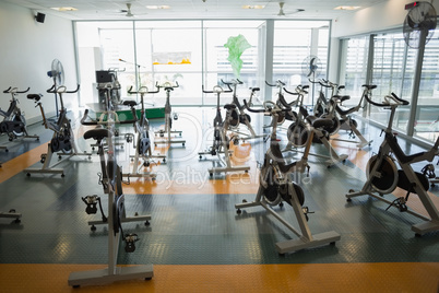Large empty fitness studio with spin bikes