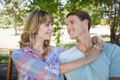 Cute couple sitting on bench in the park