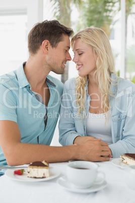 Hip young couple having desert and coffee together