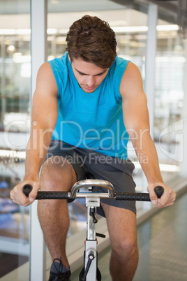 Focused fit man on the spin bike