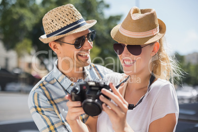 Hip young couple looking at their camera