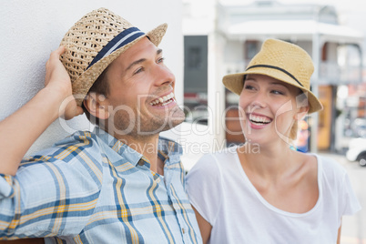 Young hip couple sitting on bench