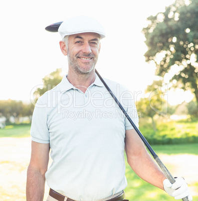 Smiling handsome golfer looking away