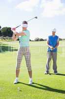 Golfing couple teeing off for the day