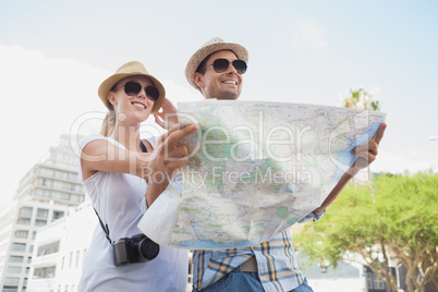 Young tourist couple using the map