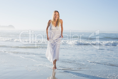 Pretty blonde at the beach in white sundress