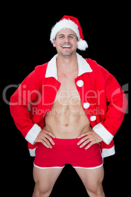 Smiling muscular man posing in sexy santa outfit
