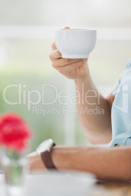 Man sitting in cafe having coffee