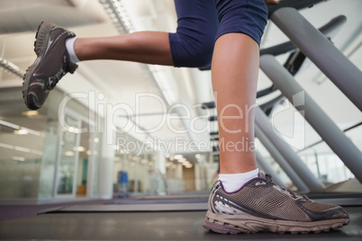 Fit woman running on the treadmill