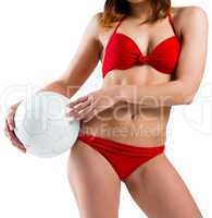 Fit girl in bikini holding football