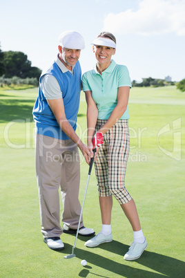 Happy couple putting the ball together